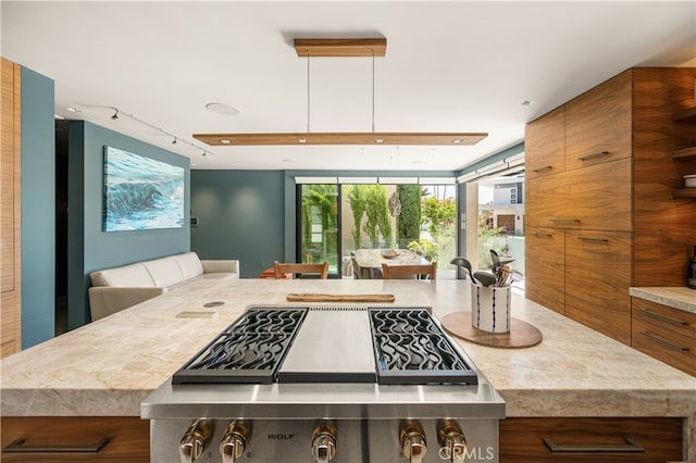 5429 E The Toledo, Long Beach, CA 90803 - kitchen with brown cabinetry, rail lighting, modern cabinets, open floor plan, and light countertops