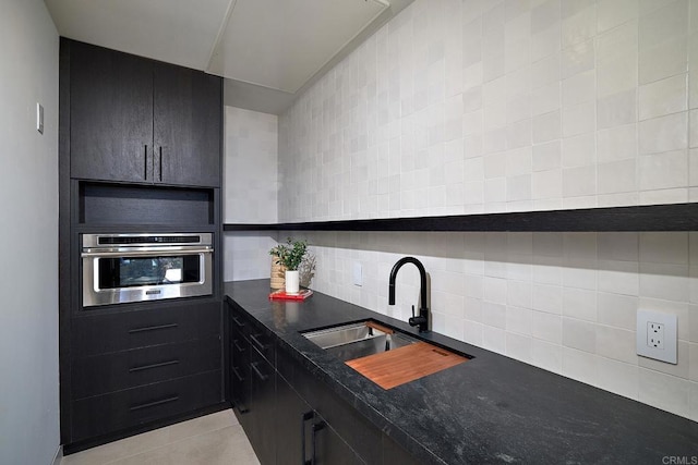 537 N Granados Ave, Solana Beach, CA 92075 - kitchen featuring oven, dark countertops, backsplash, and light tile patterned floors