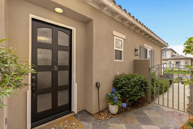6774 Caurina Ct, Carlsbad, CA 92011 - entrance to property featuring stucco siding and a gate
