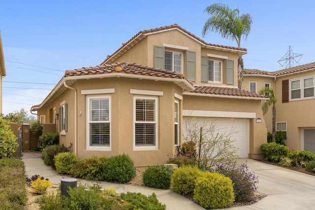 6774 Caurina Ct, Carlsbad, CA 92011 - mediterranean / spanish house with driveway, stucco siding, an attached garage, and a tiled roof