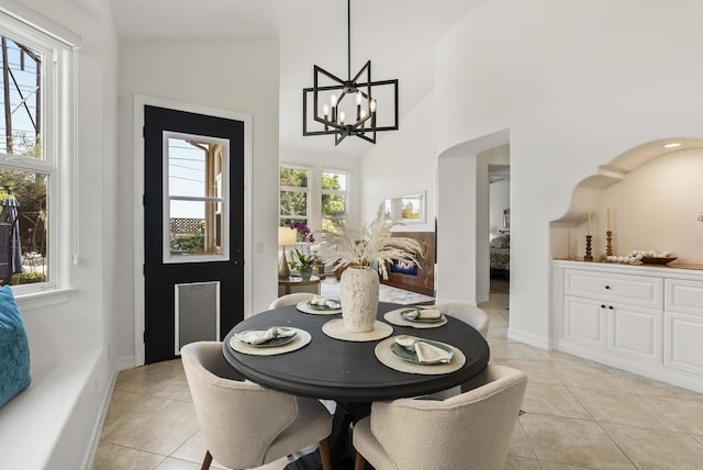 6774 Caurina Ct, Carlsbad, CA 92011 - dining area with light tile patterned floors, a chandelier, and high vaulted ceiling