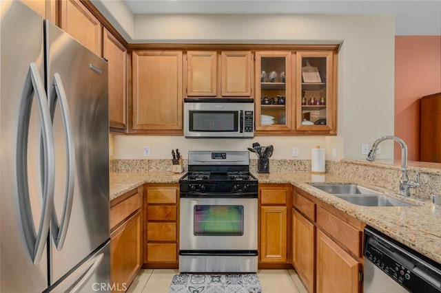 8036 Picasso, Stanton, CA 90680 - kitchen featuring appliances with stainless steel finishes, brown cabinets, and light stone countertops