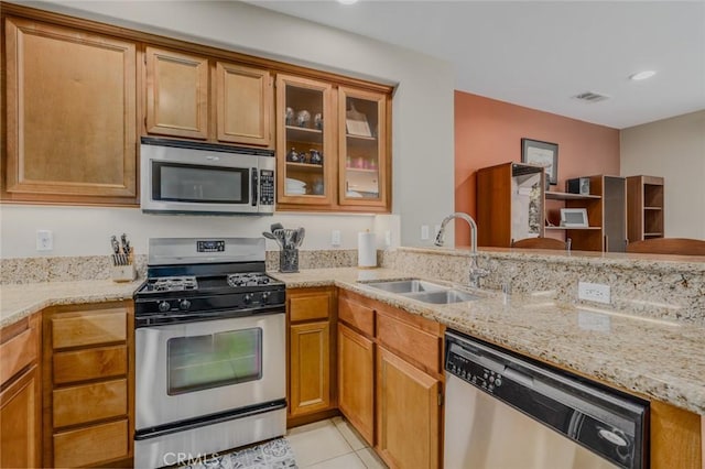 8036 Picasso, Stanton, CA 90680 - kitchen with stainless steel appliances, light stone counters, brown cabinetry, and recessed lighting
