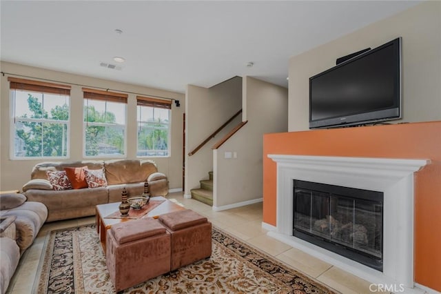 8036 Picasso, Stanton, CA 90680 - living room featuring stairs, light tile patterned flooring, and a glass covered fireplace
