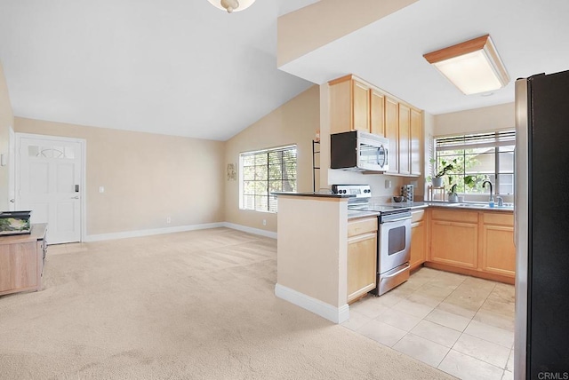 3665 Grove St Unit 271, Lemon Grove, CA 91945 - kitchen featuring stainless steel appliances, light brown cabinets, open floor plan, light carpet, and lofted ceiling