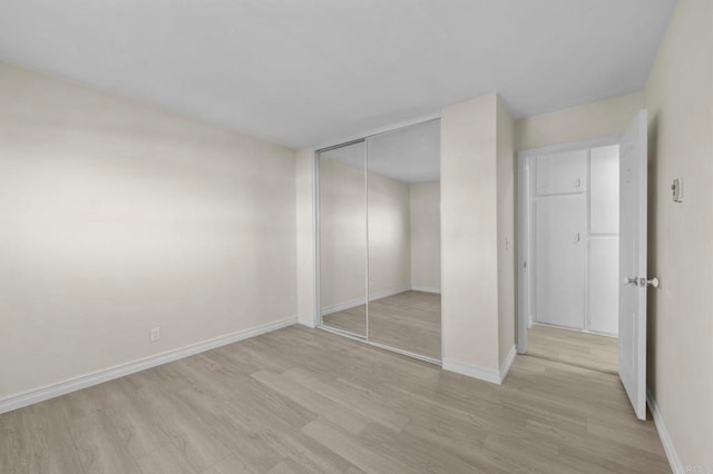8649 Lake Murray Blvd Unit 4, San Diego, CA 92119 - unfurnished bedroom featuring light wood-style flooring and a closet