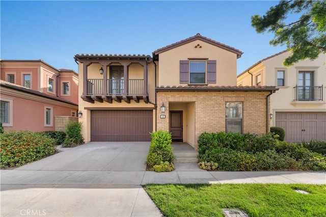 112 Velvet Leaf, Irvine, CA 92620 - mediterranean / spanish home with a balcony, an attached garage, driveway, and stucco siding