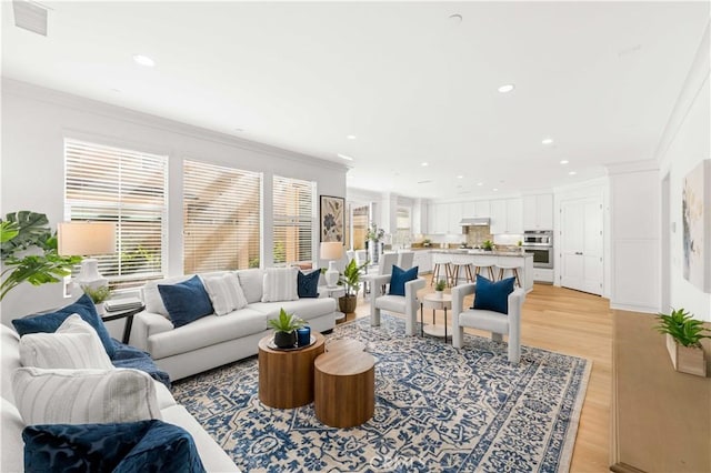112 Velvet Leaf, Irvine, CA 92620 - living room featuring ornamental molding, recessed lighting, and light wood-style flooring