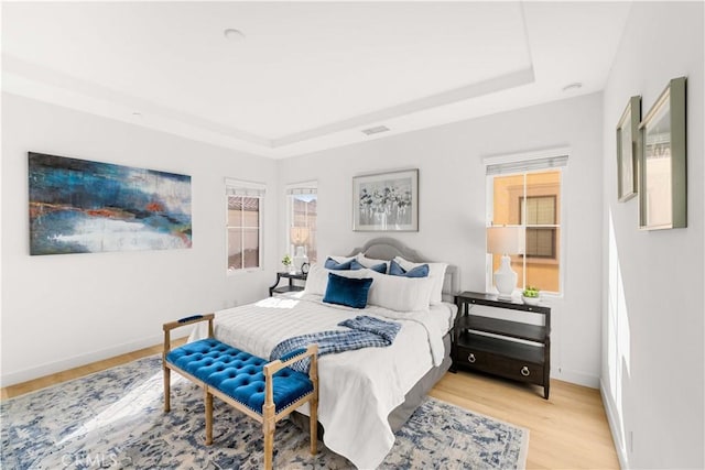 112 Velvet Leaf, Irvine, CA 92620 - bedroom featuring a tray ceiling and light wood-style floors