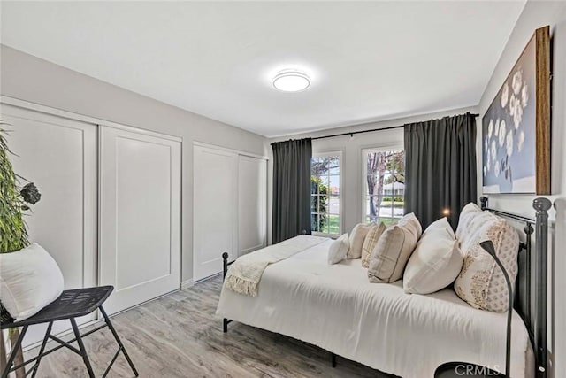 10912 Nighthawk Cir, Fountain Valley, CA 92708 - bedroom featuring light wood-style flooring and multiple closets