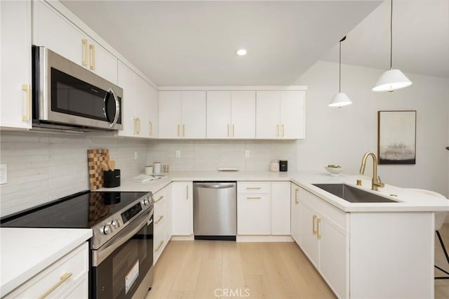 45 Oaktree Ln, Rolling Hills Estates, CA 90274 - kitchen with stainless steel appliances, a peninsula, tasteful backsplash, light wood-style flooring, and light countertops