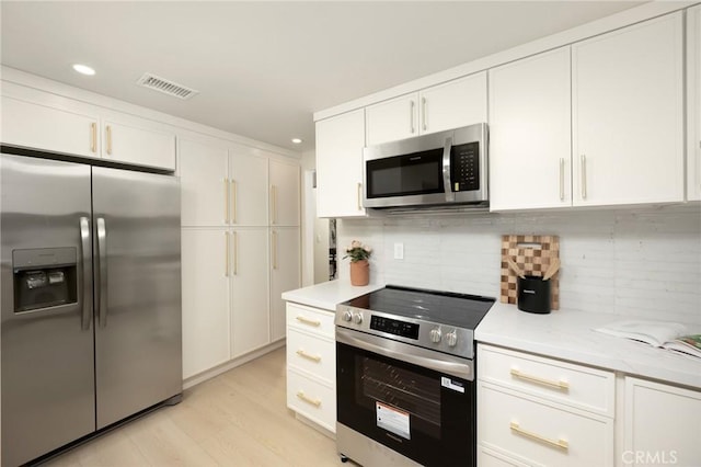 45 Oaktree Ln, Rolling Hills Estates, CA 90274 - kitchen with appliances with stainless steel finishes, white cabinets, light wood-type flooring, tasteful backsplash, and recessed lighting