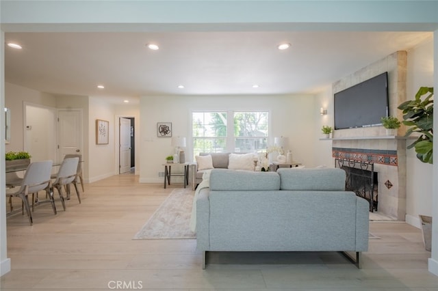 6535 Comanche Ave, Winnetka, CA 91306 - living room featuring a fireplace, light wood-style floors, and recessed lighting