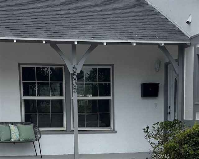 6535 Comanche Ave, Winnetka, CA 91306 - view of home's exterior featuring a shingled roof, stucco siding, and a porch