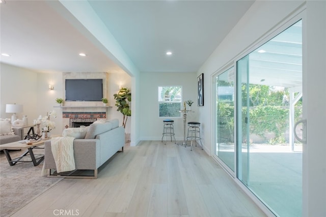 6535 Comanche Ave, Winnetka, CA 91306 - living room with light wood-style flooring, recessed lighting, and a stone fireplace