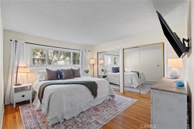5160 Atherton Unit 73, Long Beach, CA 90815 - bedroom featuring multiple closets, a textured ceiling, and wood finished floors