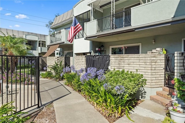 5160 Atherton Unit 73, Long Beach, CA 90815 - view of exterior entry with stucco siding and a gate