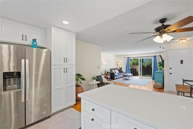 5160 Atherton Unit 73, Long Beach, CA 90815 - kitchen featuring stainless steel fridge with ice dispenser, open floor plan, light tile patterned floors, white cabinets, and light stone countertops