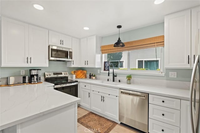 5160 Atherton Unit 73, Long Beach, CA 90815 - kitchen with stainless steel appliances, white cabinetry, light stone counters, recessed lighting, and light tile patterned floors