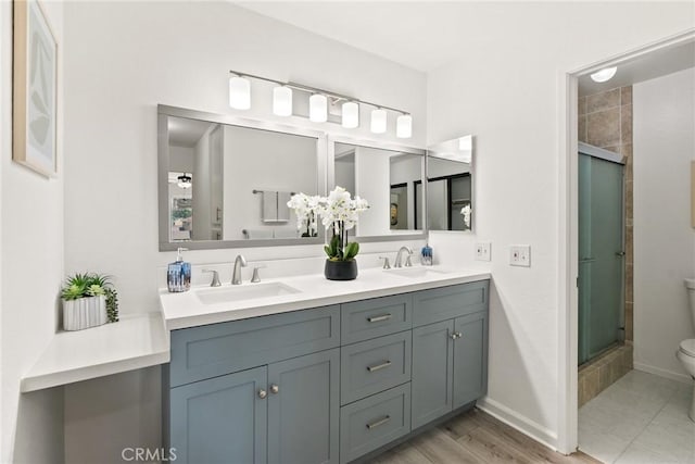 560 N Brea Blvd Unit 24, Brea, CA 92821 - bathroom with double vanity, a shower with shower door, and wood finished floors