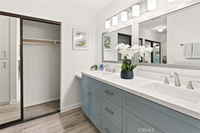 560 N Brea Blvd Unit 24, Brea, CA 92821 - bathroom featuring double vanity, wood finished floors, and a spacious closet