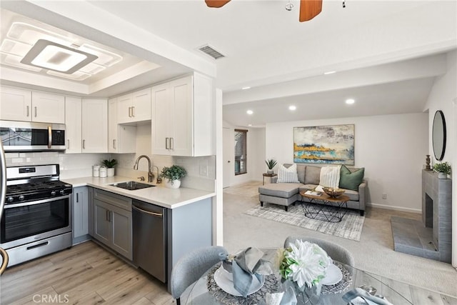 560 N Brea Blvd Unit 24, Brea, CA 92821 - kitchen with appliances with stainless steel finishes, light countertops, recessed lighting, gray cabinetry, and tasteful backsplash