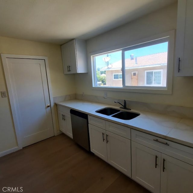 4739 Ivy St, Pico Rivera, CA 90660 - kitchen with stainless steel dishwasher, wood finished floors, light countertops, and white cabinets