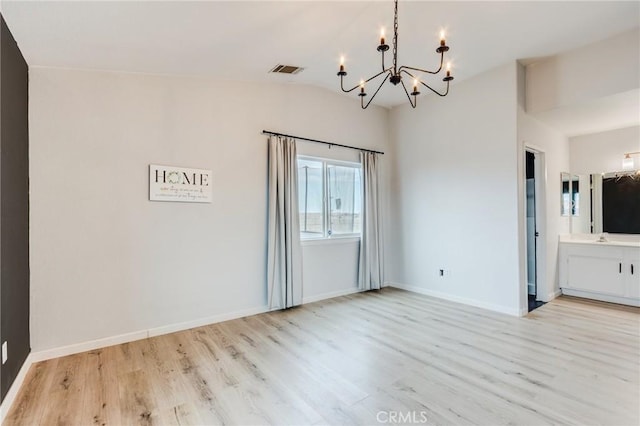 13432 Jubilee Pl, Victorville, CA 92395 - unfurnished dining area with a chandelier, light wood-style floors, and vaulted ceiling