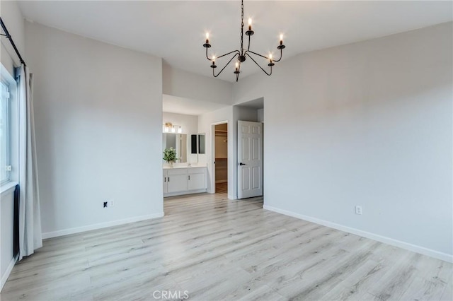 13432 Jubilee Pl, Victorville, CA 92395 - empty room with a chandelier and light wood-type flooring