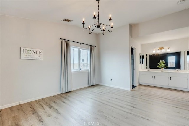 13432 Jubilee Pl, Victorville, CA 92395 - unfurnished dining area with a chandelier, light wood-style flooring, and lofted ceiling