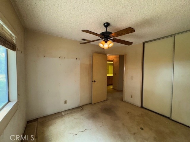 4773 Mount Rainier St, Jurupa Valley, CA 92509 - unfurnished bedroom featuring multiple windows, a closet, ceiling fan, and a textured ceiling
