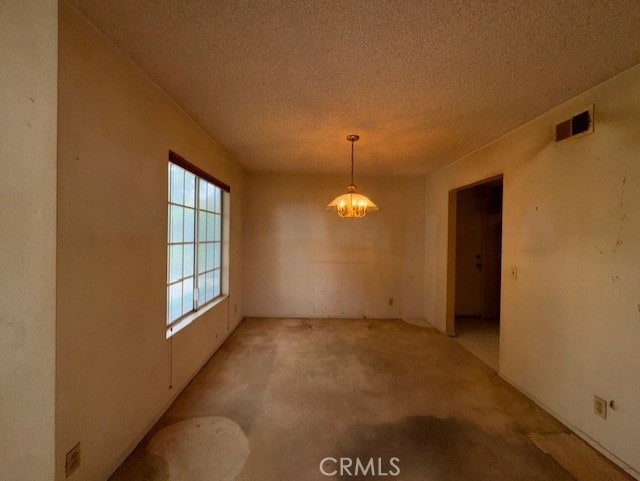 4773 Mount Rainier St, Jurupa Valley, CA 92509 - unfurnished dining area with light colored carpet, a chandelier, and a textured ceiling