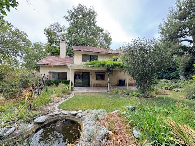 4773 Mount Rainier St, Jurupa Valley, CA 92509 - back of house featuring a chimney, stucco siding, a patio, and a tiled roof