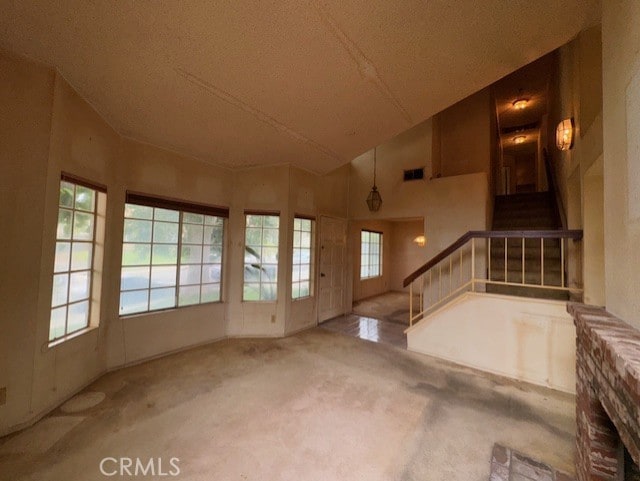4773 Mount Rainier St, Jurupa Valley, CA 92509 - unfurnished living room with stairs, carpet, and vaulted ceiling