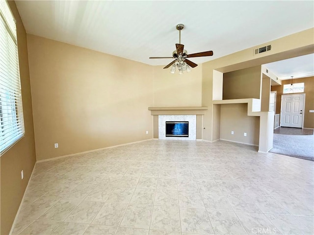 42977 Calle Londe, Temecula, CA 92592 - unfurnished living room featuring a ceiling fan, light tile patterned floors, and a glass covered fireplace