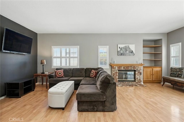 31397 Heitz Ln, Temecula, CA 92591 - living area featuring light wood-style floors, built in features, and a fireplace