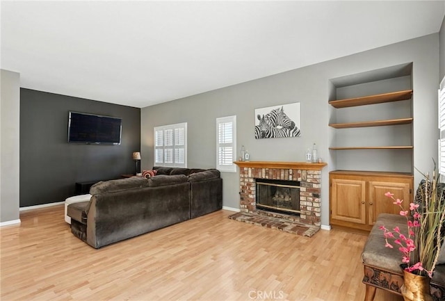 31397 Heitz Ln, Temecula, CA 92591 - living room with light wood-type flooring, a brick fireplace, and built in features
