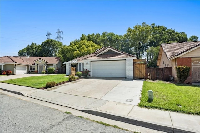 1422 Deborah Pl, Beaumont, CA 92223 - view of front facade featuring a tiled roof, driveway, a gate, a garage, and brick siding