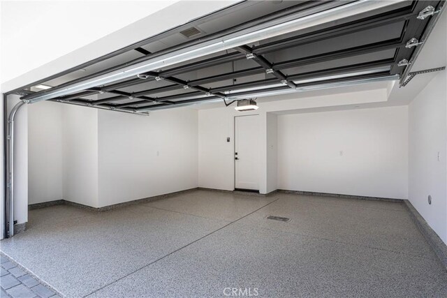 1567 Hi Point St, Los Angeles, CA 90035 - garage with a garage door opener and baseboards