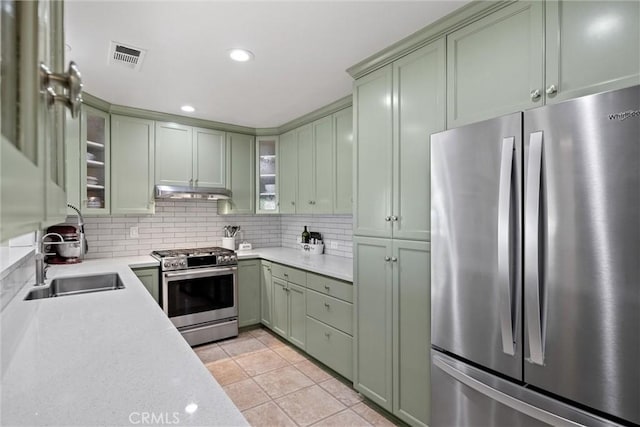 4187 County Road M, Orland, CA 95963 - kitchen featuring stainless steel appliances, green cabinetry, under cabinet range hood, light countertops, and light tile patterned floors