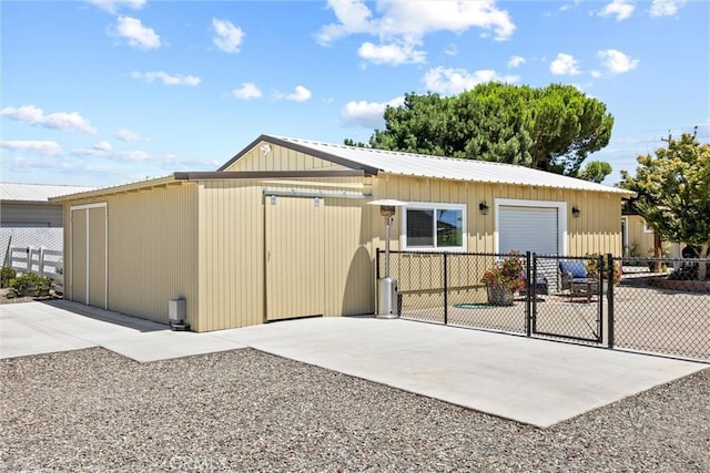 4187 County Road M, Orland, CA 95963 - rear view of house with an attached garage, a metal roof, and driveway