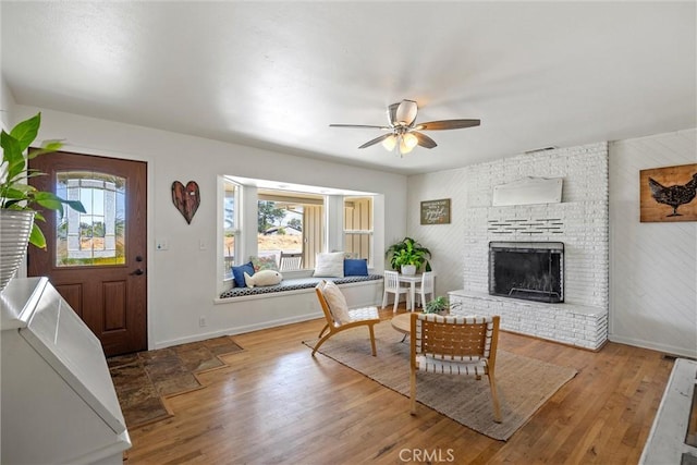 4187 County Road M, Orland, CA 95963 - living area with healthy amount of natural light, a ceiling fan, a fireplace, and wood finished floors