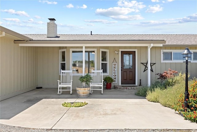 4187 County Road M, Orland, CA 95963 - view of exterior entry featuring covered porch, a chimney, and a shingled roof