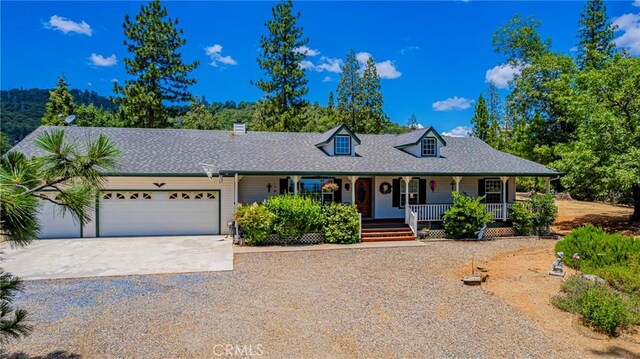 53235 Finegold Creek Ct, North Fork, CA 93643 - view of front facade featuring driveway, covered porch, a garage, and roof with shingles