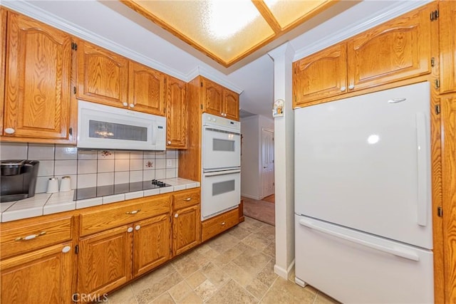 53235 Finegold Creek Ct, North Fork, CA 93643 - kitchen featuring white appliances, backsplash, tile counters, and brown cabinetry