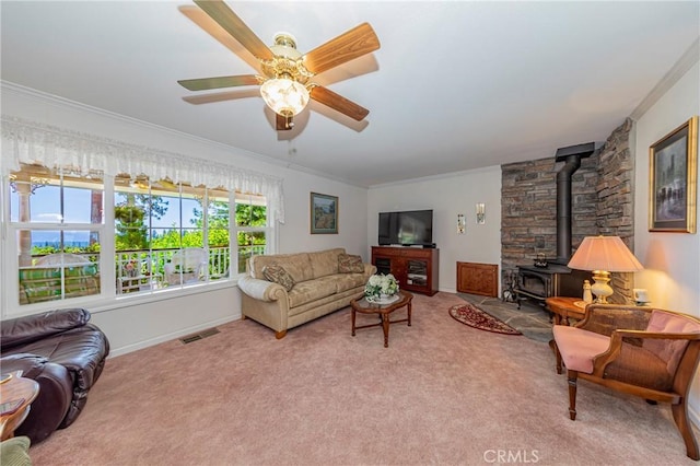 53235 Finegold Creek Ct, North Fork, CA 93643 - living area with a wood stove, ornamental molding, carpet, and a ceiling fan