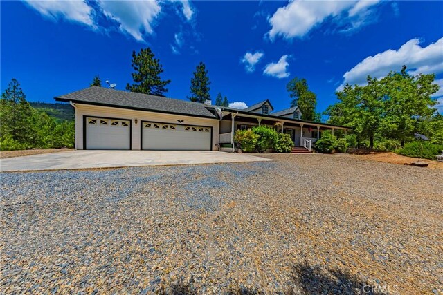 53235 Finegold Creek Ct, North Fork, CA 93643 - view of front facade with driveway, a garage, and a porch