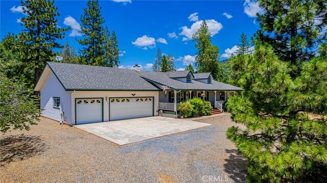 53235 Finegold Creek Ct, North Fork, CA 93643 - view of front of property featuring driveway, a porch, a garage, a chimney, and a shingled roof
