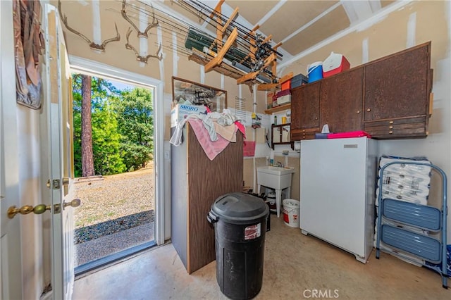 53235 Finegold Creek Ct, North Fork, CA 93643 - garage featuring freestanding refrigerator and a sink