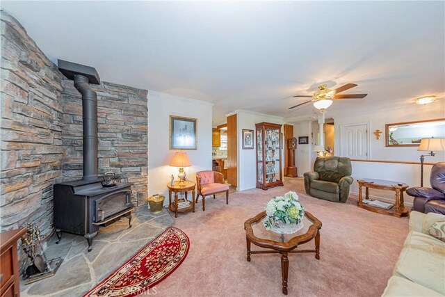53235 Finegold Creek Ct, North Fork, CA 93643 - living area featuring a wood stove, carpet flooring, ceiling fan, and crown molding